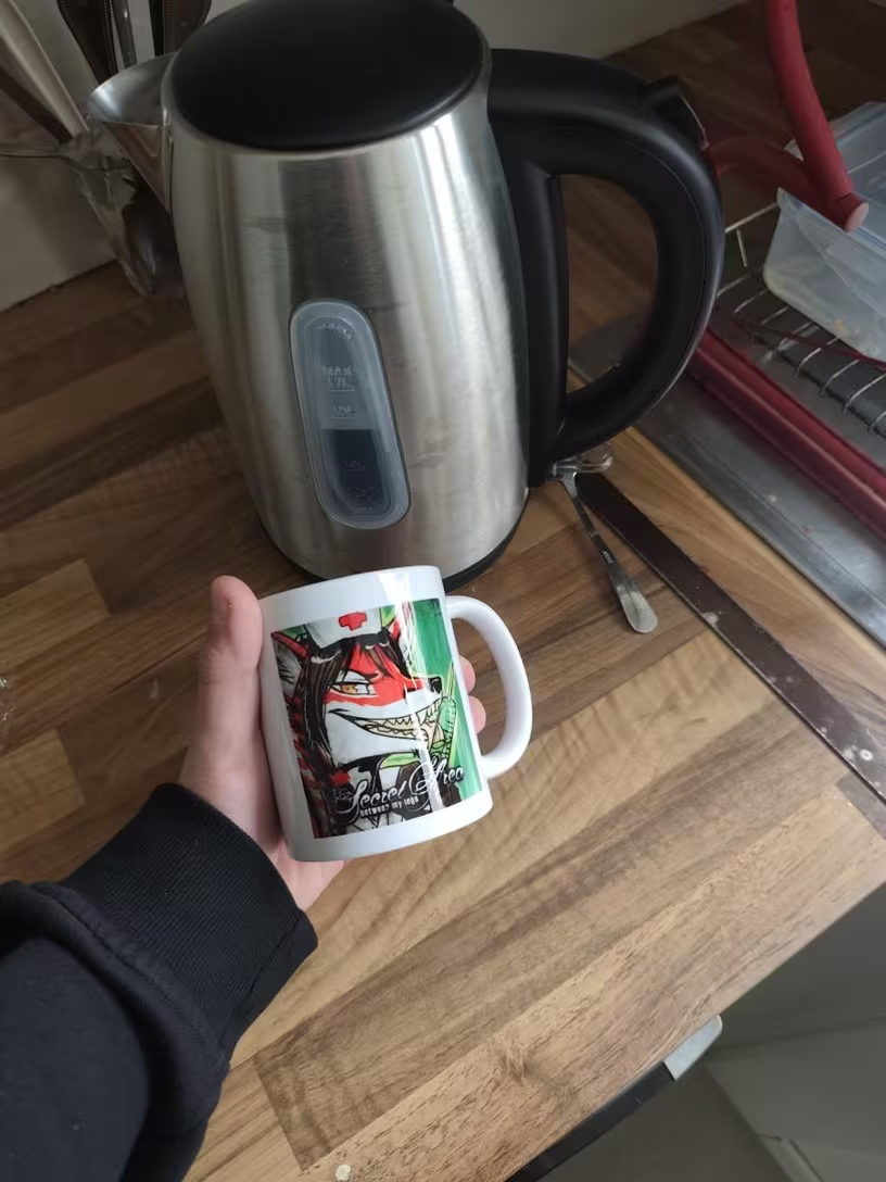 Hand holding a custom printed mug with vibrant artwork — a perfect personalized gift